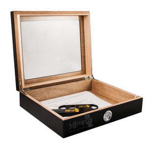 A 20 cigar capacity Wooden humidor finished in black lacquer and with a glass top